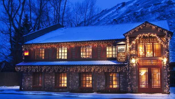 A stone building with a stone facade, multiple windows, and a sign that reads "Inn on the Creek". - Inn on the Creek (Jackson)