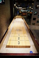 A shuffleboard table with numbered scoring areas.