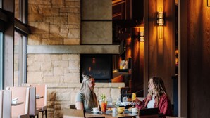 A cozy restaurant with stone walls and wooden furniture.