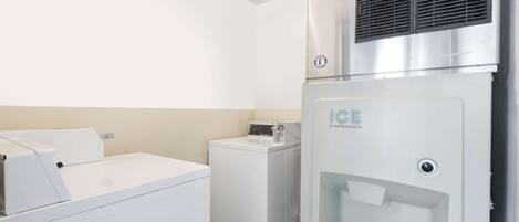 A laundry area with a washing machine, a dryer, and an ice dispenser.