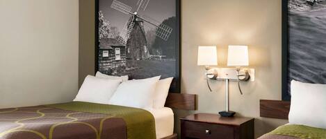 A hotel room with two beds, a nightstand with lamps, and a large windmill painting on the wall.