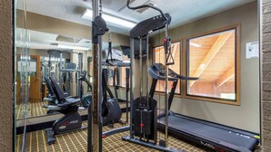 A gym with cardio machines, weightlifting equipment, and a treadmill. - Baymont by Wyndham Harvard (Harvard)