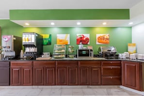 A breakfast bar with a coffee machine, toaster, and various food items. - Quality Inn Sycamore - DeKalb (Sycamore)