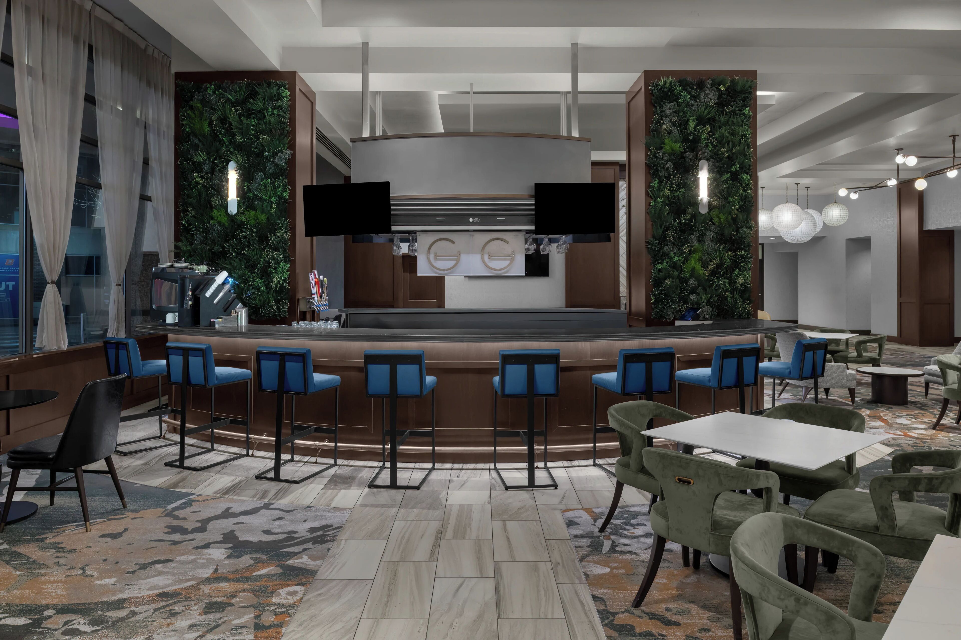 A bar area with a counter, bar stools, and a seating area with tables and chairs.