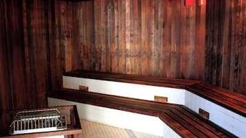 A wooden interior with a bench and a metal rack.