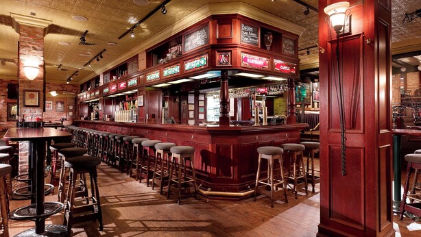 A bar area with wooden stools, a bar counter, and a decorative ceiling. - Club Quarters Hotel Faneuil Hall, Boston (Boston)