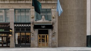 A building with a large number '161' sign, Club Quarters flags, and a storefront with 'STLE PUB' signage. - Club Quarters Hotel Faneuil Hall, Boston (Boston)