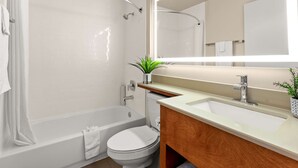 Une salle de bain moderne avec une baignoire, des toilettes et un lavabo.