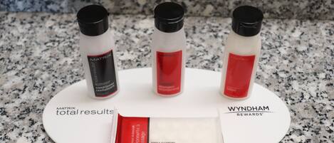 Three bottles of Matrix Total Results shampoo and a bar of Matrix Gentle Cleansing massage bar on a granite countertop.