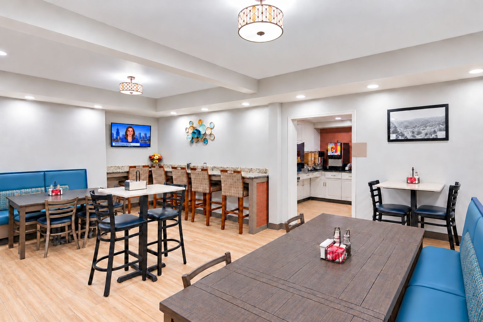 Una habitación de hotel moderna con comedor, cocina y zona de estar.