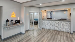 A modern coffee station with a neon sign, a counter with a patterned backsplash, and a wooden floor. - SureStay by Best Western Salt Lake City Downtown (Salt Lake City)