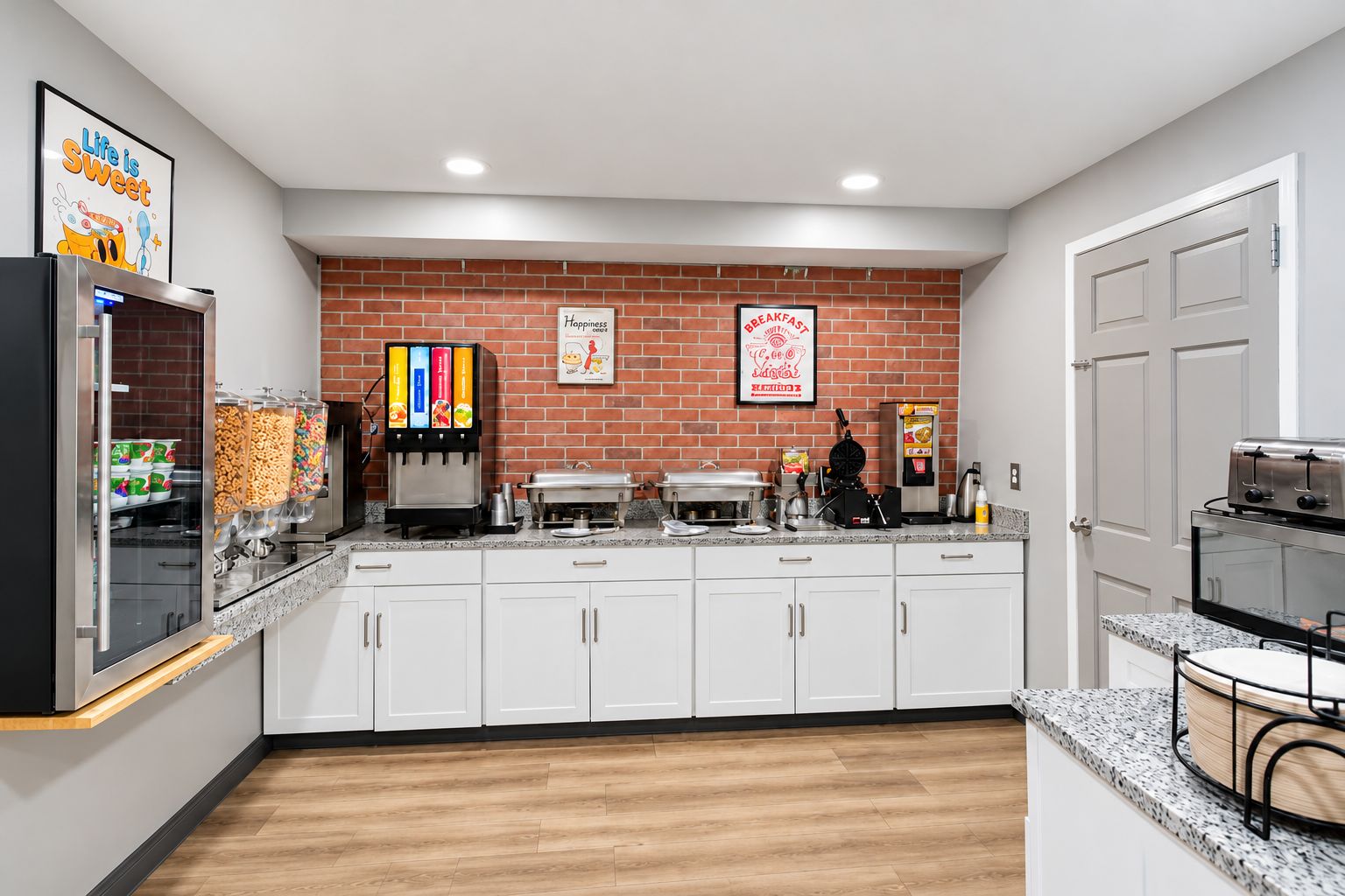 A kitchen with a brick wall, white cabinets, a coffee machine, and a toaster.