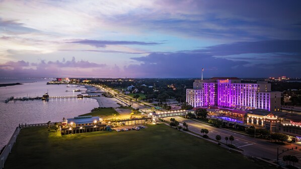 A large hotel with a prominent building and a waterfront view. - Harrah's Gulf Coast Hotel & Casino - A Caesars Rewards Destination (Biloxi)