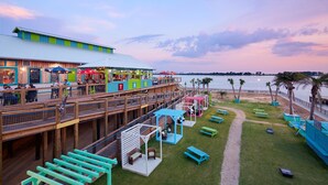 A waterfront restaurant with outdoor seating, a deck, and a view of the ocean. - Harrah's Gulf Coast Hotel & Casino - A Caesars Rewards Destination (Biloxi)