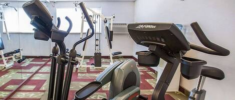 A gym with treadmills, elliptical machines, and a stair climber.