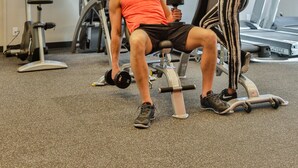 A gym with exercise equipment, including treadmills and weight machines.