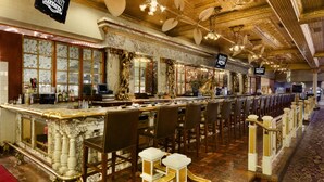 A bar area with marble counters, leather chairs, and a red carpet. - Main Street Station Hotel, Casino and Brewery (Las Vegas)