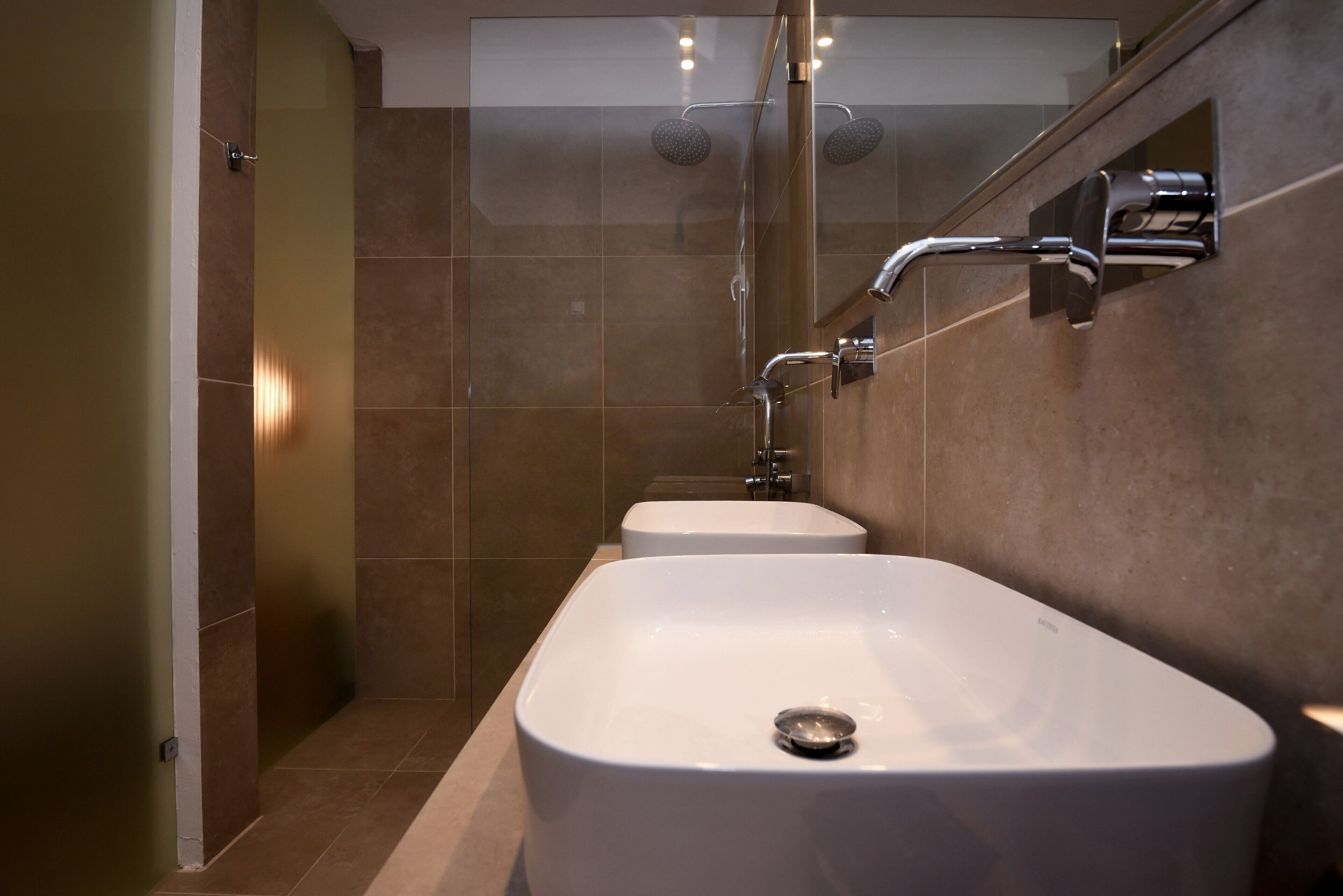 A modern bathroom with a large white bathtub, a separate shower area, and a glass-enclosed shower stall.
