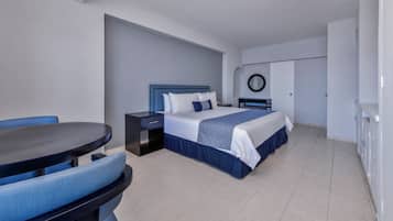 A modern hotel room with a bed, a desk, and a chair.