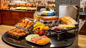 A buffet with various food items including pastries, fruits, and sandwiches. - ibis Styles Bournemouth (Bournemouth)