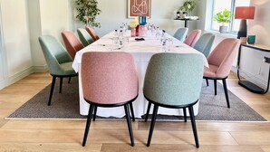 A conference room with a long table, multiple chairs, and various items on the table. - ibis Styles Bournemouth (Bournemouth)