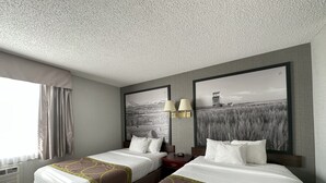 A hotel room with two beds, a large window with curtains, a wall-mounted air conditioner, and two wall-mounted lamps. - Super 8 by Wyndham Lethbridge (Lethbridge)