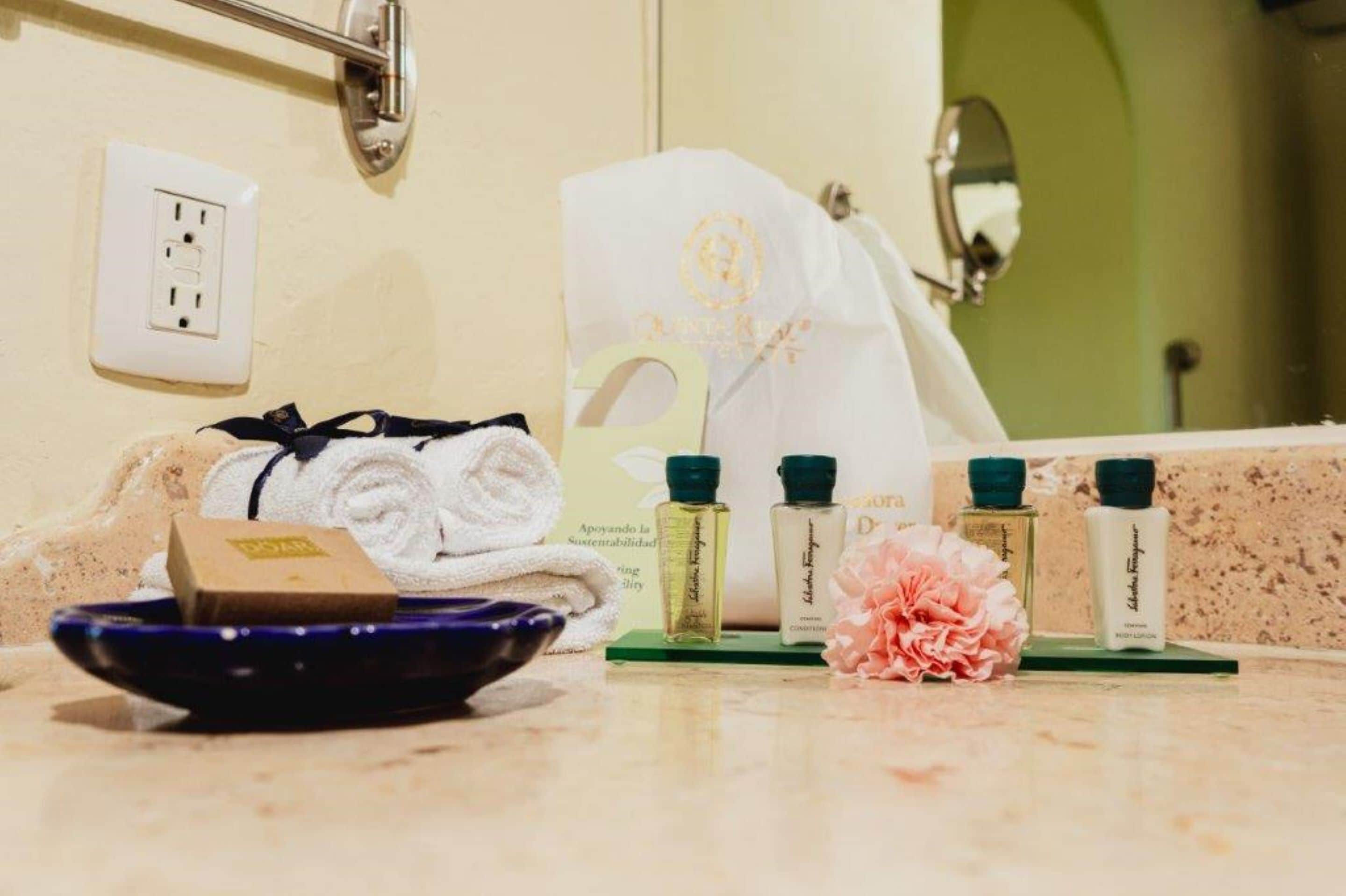 designer toiletries, hair dryer, bathrobes, slippers