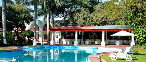 Una piscina al aire libre, sombrillas