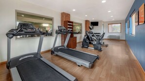 A gym with treadmills, elliptical machines, and a wooden floor. - Comfort Suites Mason near Kings Island (Mason)