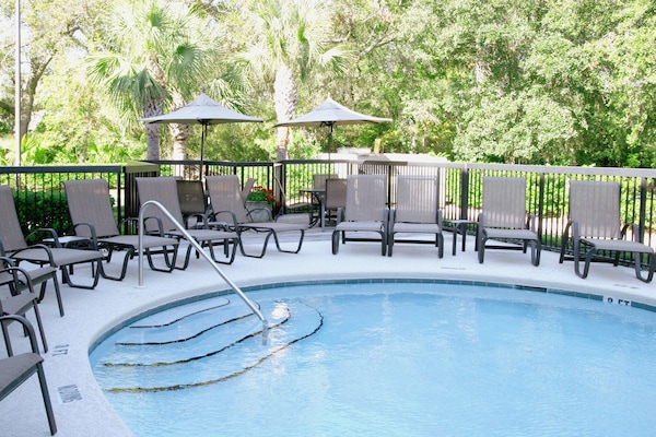 Outdoor pool, open 7:00 AM to midnight, pool umbrellas, sun loungers