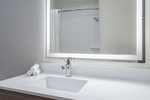 A bathroom with a white sink, a mirror, and a shower curtain. - Holiday Inn Express & Suites American Fork - North Provo by IHG (American Fork)