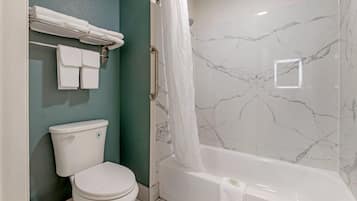 A bathroom with a toilet, a bathtub, and a shower curtain.
