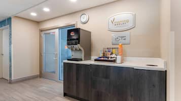 A reception area with a coffee machine, a clock, and a sign for 'Morning Meadow' and 'Dream Cup'.