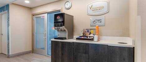 A reception area with a coffee machine, a clock, and a sign for 'Morning Meadow' and 'Dream Cup'.