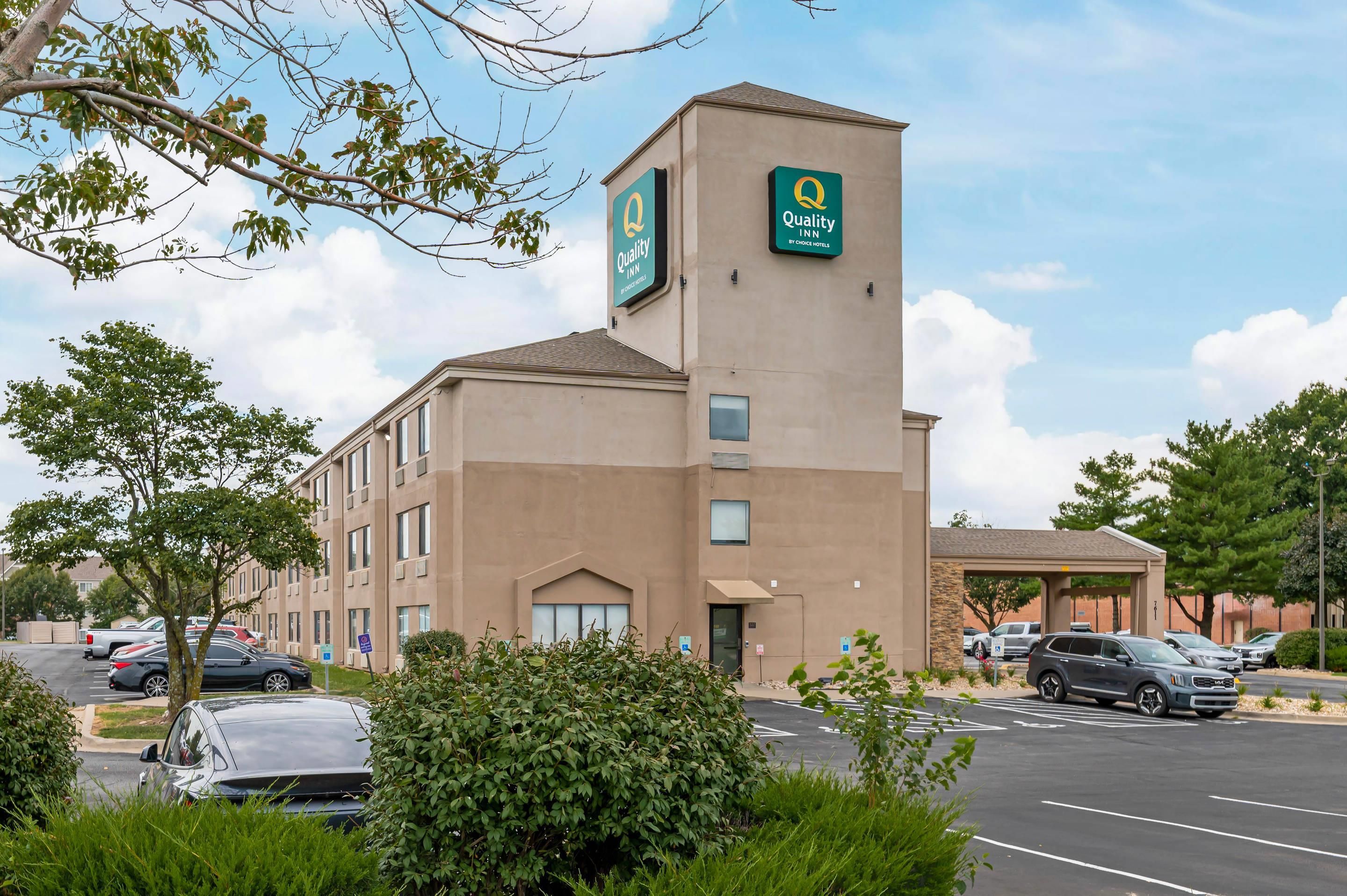 A hotel with a prominent sign for Quality Inn by Choice Hotels.