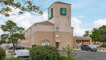 A hotel with a prominent sign for Quality Inn by Choice Hotels.