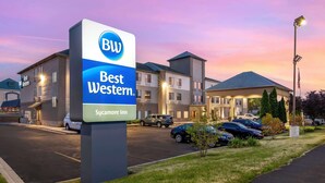 A Best Western hotel with a signboard, parking area, and buildings.