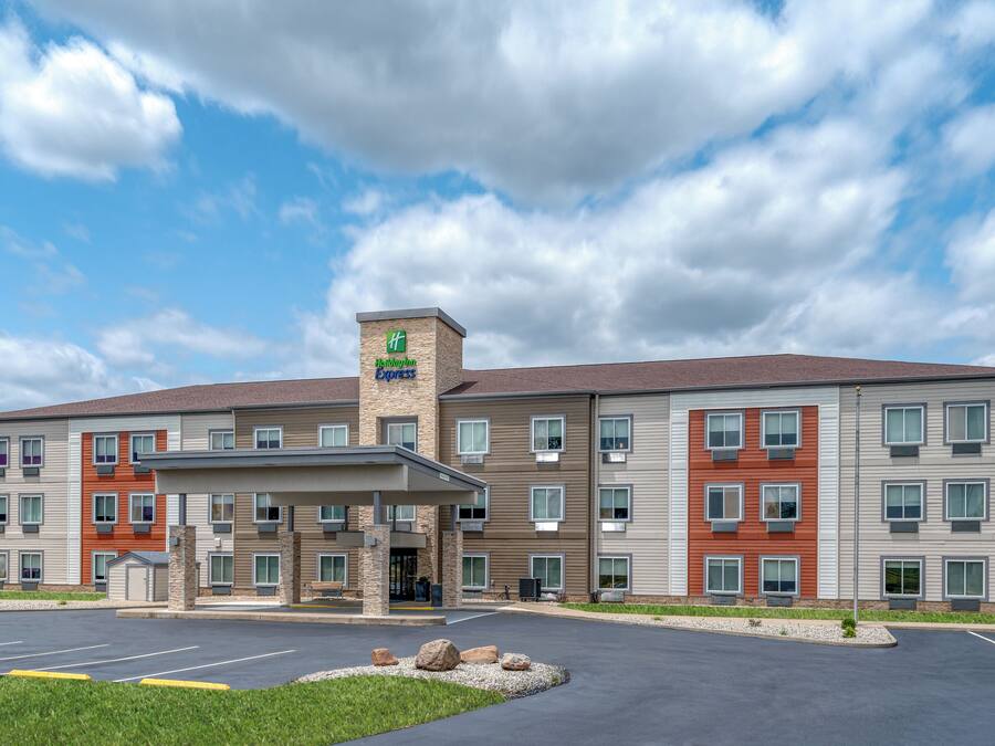 A Holiday Inn Express hotel with a brick facade, multiple balconies, and a covered entrance.