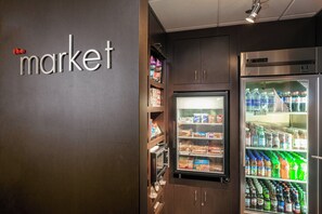 A vending machine area with snacks and drinks, a microwave, and a refrigerator stocked with beverages. - Courtyard by Marriott Stockton (Stockton)