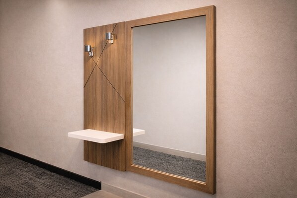 Une salle de bain moderne avec un meuble-lavabo en bois, un miroir et une petite étagère.