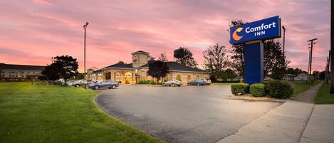 A Comfort Inn hotel with a parking lot and a grassy area in front.