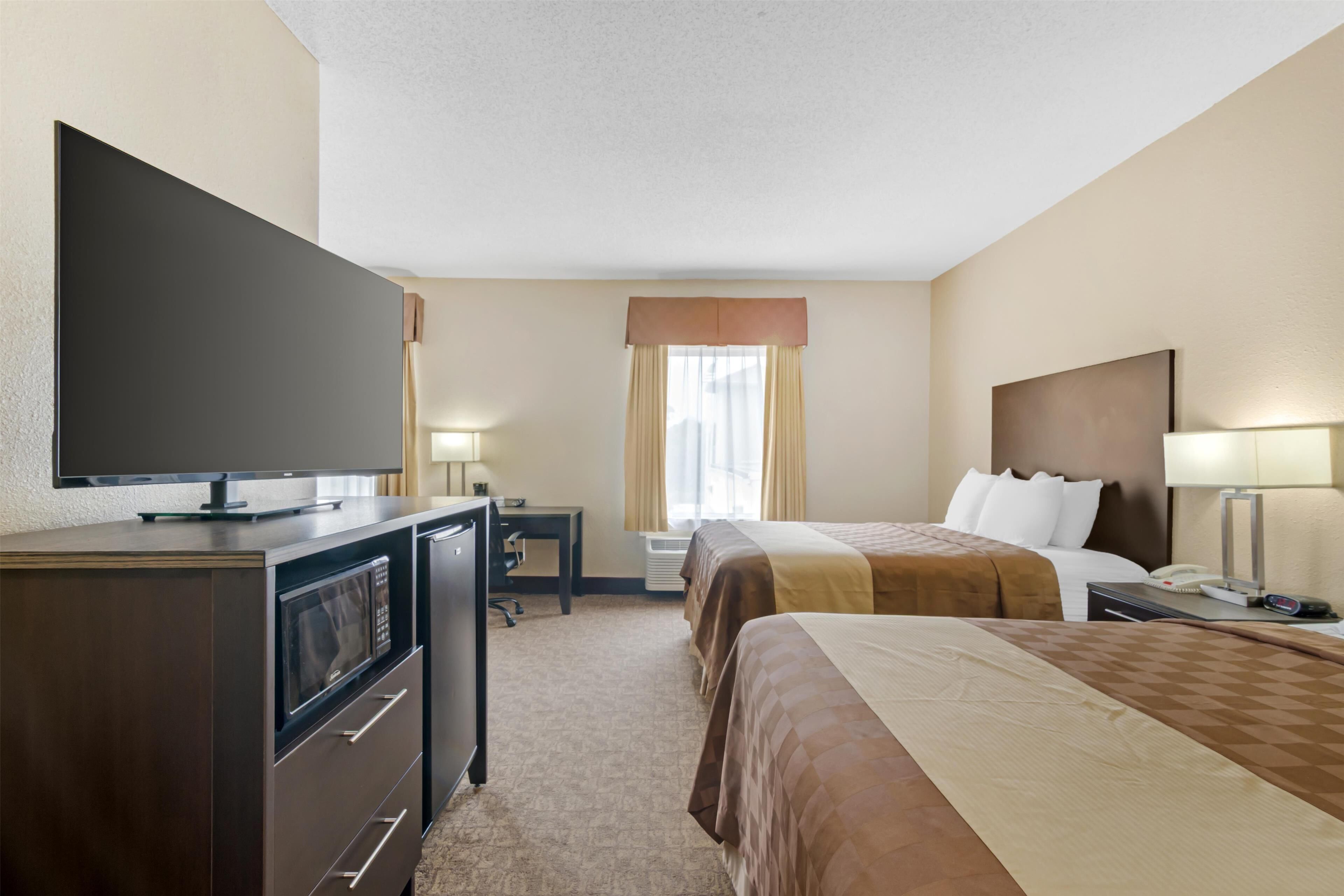 suite, 2 queen beds, non smoking, microwave (larger room;with sofabed) | 1 bedroom, desk, laptop workspace, blackout curtains