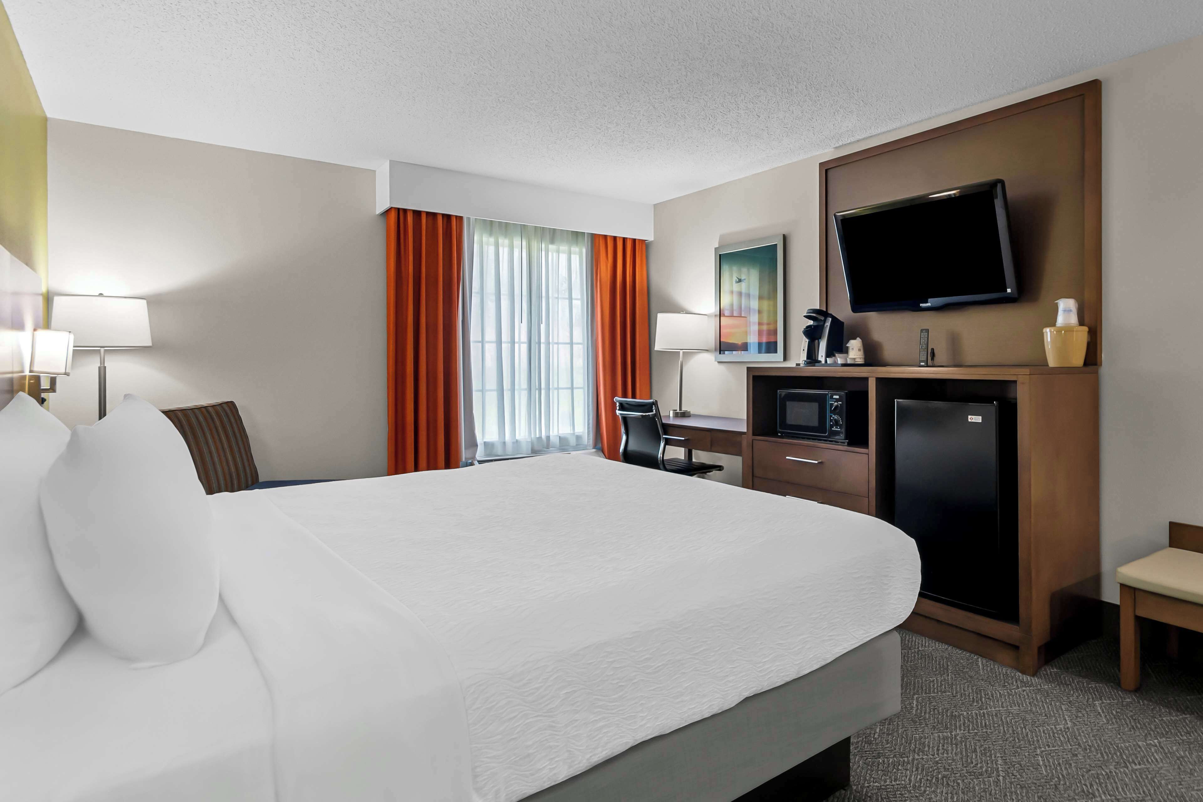 standard room, 1 king bed, non smoking, refrigerator & microwave | in-room safe, desk, laptop workspace, iron/ironing board