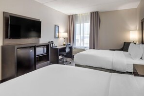 A hotel room with a flat-screen TV, a desk with a chair, a bed, and a window with curtains. - Comfort Inn & Suites Greer - Greenville (Greer)