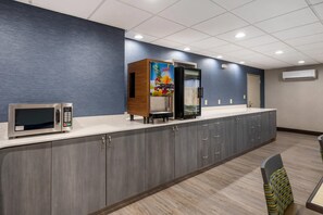 A kitchenette with a microwave, refrigerator, and a juice dispenser. - Comfort Inn & Suites Greer - Greenville (Greer)
