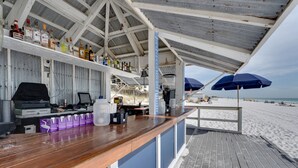 A beachside bar with wooden counters, a grill, and a view of the beach. - Sandestin Golf and Beach Resort (Miramar Beach)