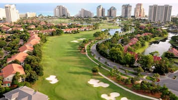 Surrounded by water and lush trees, this golf course offers a serene residential setting with easy access to recreational activities.