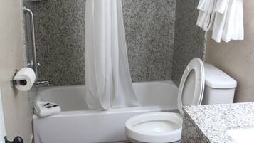 A bathroom with a shower, toilet, and sink.