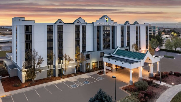 A modern hotel with a flat roof, large windows, and a covered entrance. - Hyatt Place Denver Airport (Aurora)