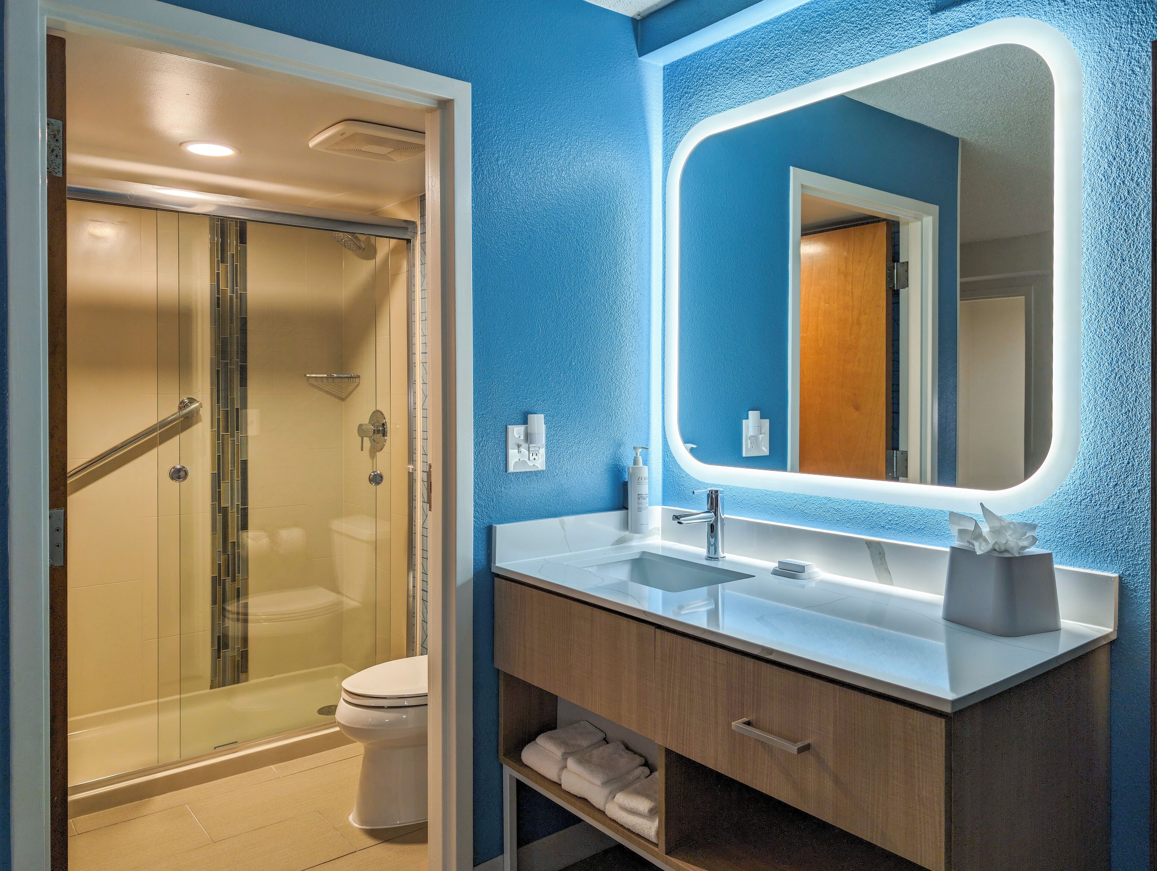 designer toiletries, hair dryer, towels, soap